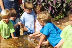 children playing in fountain